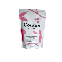 Load image into Gallery viewer, Image of Conure coffee Bright morning 250g front  white bag with pink illustrations