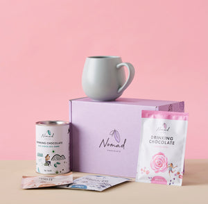 Image of Nomad Chocolate gift box with rose hit chocolate 40g, Robert gordon mug, Nomad chocolate West Africa 200g, and two  40g bags of hot chocolate