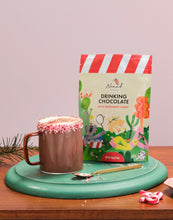 Load image into Gallery viewer, Nomad Drinking Chocolate Peppermint Candy bag with cup of hot chocolate. Decorated with crushed candy canes.