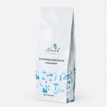 Load image into Gallery viewer, A white stand-up pouch of Nomad Chocolate Drinking Chocolate Bondi Blend, decorated with blue illustrations and text, set against a plain white background.