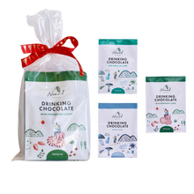 Load image into Gallery viewer, Nomad Drinking Chocolate packaging with a red ribbon on a white background. Nomad Chocolate 3 Minis hot chocolates each 40g, West Africa 45% Dark, Bondi Blend, Peppermint Candy 