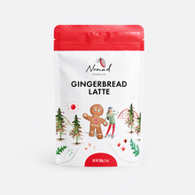 Load image into Gallery viewer, A stand-up pouch of Nomad Chocolate Gingerbread Latte on a light gray background. The packaging is white with a bright red top seal and red bottom accent, featuring an illustration of a gingerbread man, trees, and holiday decorations.