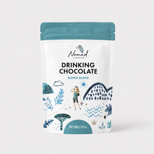 Load image into Gallery viewer, A stand-up pouch of Nomad Chocolate Drinking Chocolate Bondi Blend, 200g, featuring a white bag with a teal top and illustrated coastal artwork in blue and teal.
