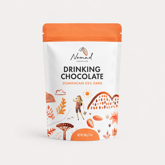 Nomad Chocolates Drinking Chocolate pouch in Dominican 55% Dark, featuring a white and orange stand-up package with illustrated tropical and outdoor motifs.