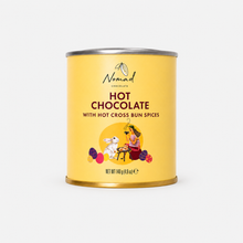 Load image into Gallery viewer, A yellow cylindrical canister of Nomad Chocolate Hot Chocolate with Hot Cross Bun Spices, featuring a silver metal lid and base, set against a plain white background.