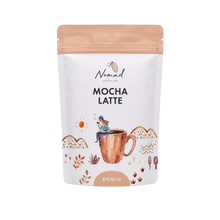 Load image into Gallery viewer, A stand-up pouch of Nomad Chocolate Mocha Latte on a plain white background. The package is white with a peach-colored resealable top and bottom band, and features an illustrated copper mug with a small person sitting on it, plus small botanical and sun motifs.