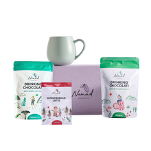 Load image into Gallery viewer, Nomad Drinking Chocolate packages with a mug on a white background. mage of Nomad chocolate gift box in lilac colour, Robert gordon mug , Nomad drinking chocolate west Africa 45% dark and nomad hot chocolate with peppermint candy 200g and gingerbread latte in the 40g bag  
