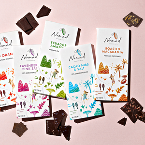Nomad Chocolate bars 72% dark with roasted macadamia, cacao nibs and sale, mango and juniper berry. Chocolate bar from Ecuador Amazon and peaces of chocolate.