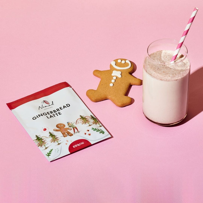 Image of 40g gingerbread latte bag, gingerbread biscuit and the drink in the glass cup with a straw.