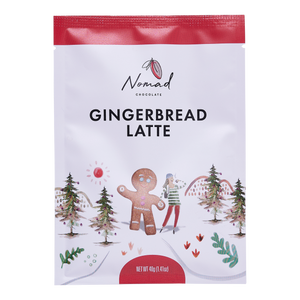 Nomad Chocolate Gingerbread Latte 40g front of the bag. Label with girls holding hands with a gingerbread man, walking through the Christmas woods. All natural ingredients, gluten free.