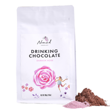 Load image into Gallery viewer, Nomad Chocolate with Damask Rose white bag with cacao and rose dust powder next to bag