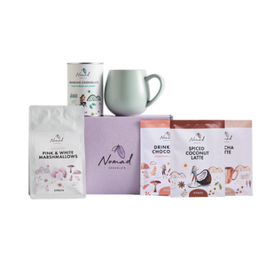 Nomad chocolate gift box in purpule, robert gordin mug in green, Nomad drinking chocolate west africa 45% dark 200g, Pink and white marshemellows, nomad drinking chocolate dominican, nomad spiced coconut latte in 40g bag, and nomad chocolate mocha latte 40g bags.