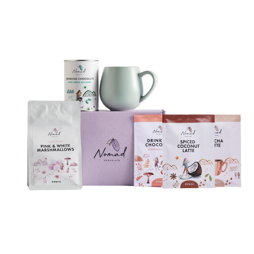 Nomad chocolate gift box in purpule, robert gordin mug in green, Nomad drinking chocolate west africa 45% dark 200g, Pink and white marshemellows, nomad drinking chocolate dominican, nomad spiced coconut latte in 40g bag, and nomad chocolate mocha latte 40g bags.