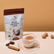 Load image into Gallery viewer, Nomad Chocolate Spiced Coconut Latte, coconut milk powder with cinnamon and spices. Gluten Free and no artificial flavouring. With drink in glas cup, cinnamon quills, star anise and  coconut flakes.