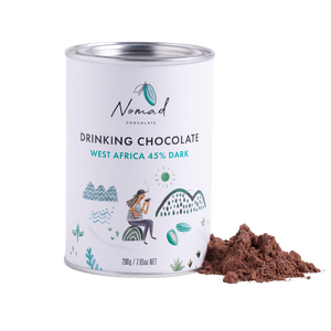 Nomad Hot Chocolate West Africa 45% Dark 200g white tin with cocoa powder next to the  tin.